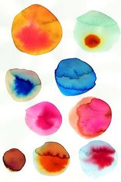 six different colors of watercolor on white paper