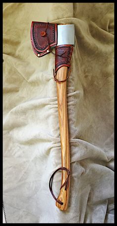 a pair of brown shoes sitting on top of a wooden shoe brush next to a pair of glasses