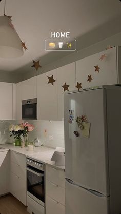 a white kitchen with stars on the ceiling