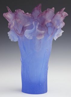 a blue vase with purple flowers in it