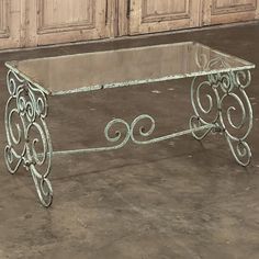 a glass table sitting on top of a cement floor