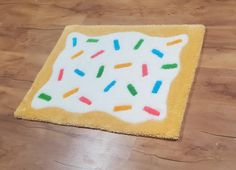 a cake with sprinkles is on the floor