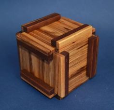 a small wooden box sitting on top of a blue surface