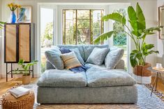 a living room filled with furniture and lots of plants