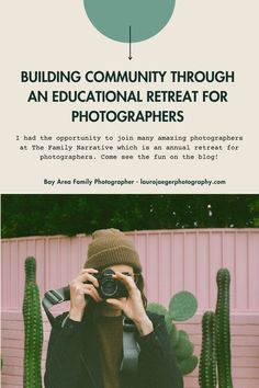 a person taking a photo with a camera in front of a cactus and pink wall