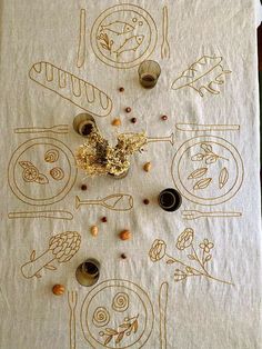 the table cloth is decorated with food and utensils