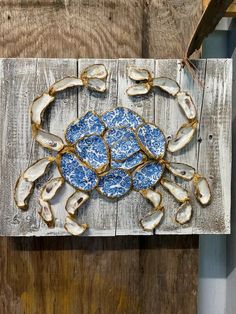 a blue and white plate sitting on top of a wooden table covered in oysters