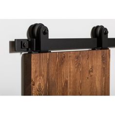 the sliding door is made out of wood and has two black handles on each side