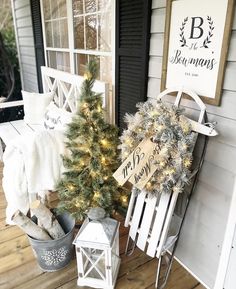 a porch decorated for christmas with white and silver decorations