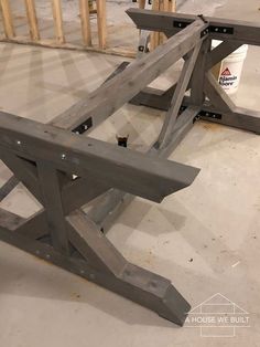 two wooden benches sitting next to each other on top of a hard wood floor in a building