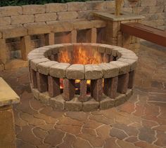 an outdoor fire pit is shown in the middle of a patio