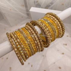 A set of 2 small half stacks of antique Gold and Pearl Bangles with Yellow Shades. Ready to Ship! Packed loose in small gift box. (No roll) Yellow Bangles Set, Yellow Bangles, Pearl Bangles, Mini Bracelet, Indian Bridal Jewelry Sets, The Bangles, Yellow Pearl, Bridal Choker, Bangles Set