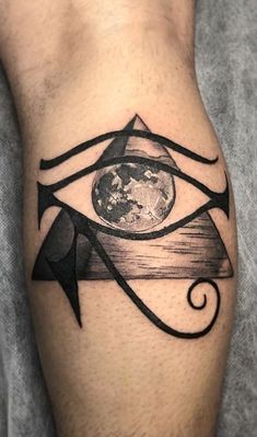 an all seeing eye tattoo on the left arm and lower half of the leg, with earth in the background