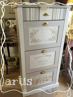 a white dresser with gold handles and drawers