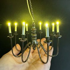 a chandelier with seven lit candles in it