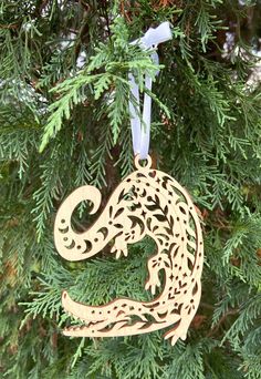 a wooden ornament hanging from a tree