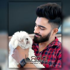 a man holding a small white dog in his lap and looking at it's face