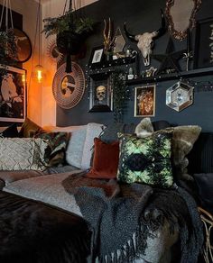 a living room filled with lots of furniture and pictures on the wall above it's headboard