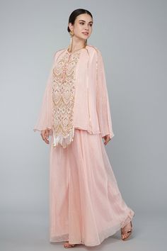 Blush pink georgette panelled embroidered lined tunic with pearls, zari work in art deco motifs and tassel details. Comes with gold zari palazzo.
Component: 2
Pattern: Embroidery
Type Of Work: Pearl,zari
Neckline: Round
Sleeve Type: Split sleeves
Fabric: Georgette,Organza
Color: Pink
Other Details: 
Pearl,zari embroidery
Art deco motifs
Tassel details
Occasion: Destination Wedding - Aza Fashions Embellished Georgette Palazzo Set With Long Sleeves, Embellished Long Sleeve Palazzo Set In Georgette, Festive Georgette Palazzo Set With Pearl Embroidery, Pink Hand Embellished Sharara For Eid, Elegant Sequined Palazzo Set In Georgette, Elegant Pink Georgette Kurta, Pink Georgette Blouse With Sheer Dupatta, Elegant Pink Blouse With Sheer Dupatta, Embellished Pink Georgette Salwar Kameez