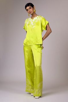 Green top with thread embroidery. Paired with a matching embroidered pant. - Aza Fashions Spring Silk Sets With Embroidered Border, Spring Sets With Intricate Embroidery And Straight Pants, Spring Sets With Embroidered Straight Pants, Embroidered Spring Sets With Straight Pants, Spring Embroidered Sets With Straight Pants, Festive Pants With Embroidered Border For Spring, Traditional Spring Sets With Trousers, Festive Embroidered Trousers Set, Green Thread