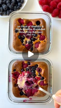 two glass containers filled with food on top of a white table next to bowls of berries and blueberries