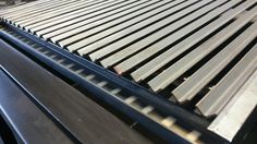 some steel bars are sitting on top of a conveyor belt in a factory area