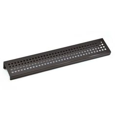 a black metal shelf with holes on it