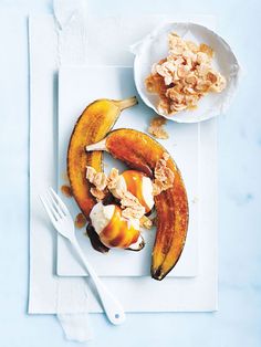 a white plate topped with bananas and granola