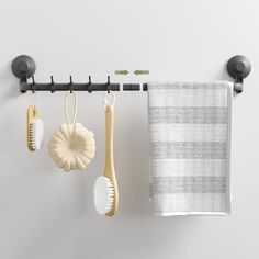 three bathroom accessories hanging on a towel rack