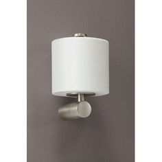 a wall mounted light with a white shade on the top and a round lamp in the middle