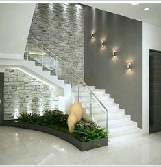 a staircase with plants and lights on the wall