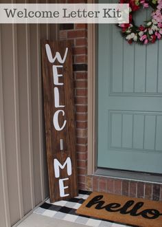 a welcome sign sitting next to a door on the front porch with a welcome mat