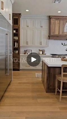 a kitchen with wooden floors and white cabinets