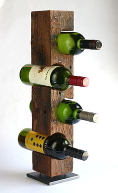 a wine rack made out of wood with several bottles on it and one bottle in the other