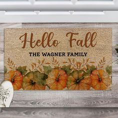 a door mat that says, hello fall the wager family with pumpkins on it