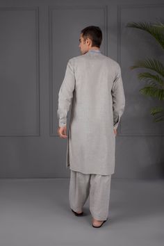 Description : 2 Piece - Kurta Shalwar :  Be your classiest self in this sleek all-grey attire. Whether you're on your way to a party or a family gathering, you're sure to look extra sharp! Details : Embroidered Front, Plain Back, Full Sleeves with Cuffs, Band Neckline, Plain Shalwar Color: Light Grey Fabric : Melange Textured fabric Country of Origin : Pakistan Care Instruction : Should be washed in gentle cycle and hung to dry. Color may bleed so please be mindful of other items with it. Discla Fitted Gray Kurta For Eid, Gray Fitted Kurta For Eid, Fitted Gray Sets For Eid, Light Grey Fabric, Men's Kurta, Pearl River, Shalwar Kameez, Full Sleeves, Textured Fabric