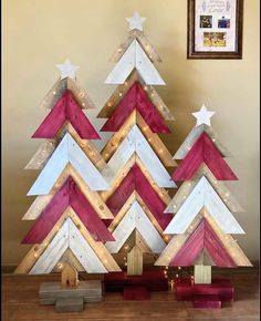 a christmas tree made out of wooden planks with white and pink stripes on it