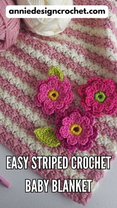 crochet baby blanket with flowers on it and yarn in the background that says easy striped crochet baby blanket