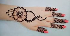 a woman's hand with henna on it and flowers painted on the palm