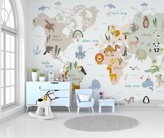 a child's room with a map of the world painted on the wall and toys