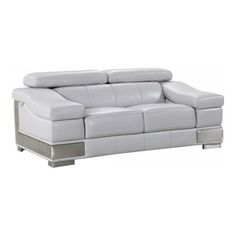 a white leather couch sitting on top of a wooden table