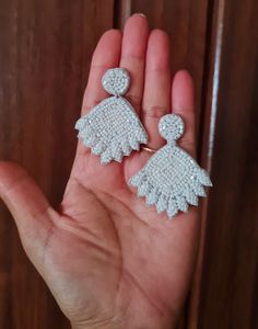 Handmade white beaded flower bridal earrings. The stunning pair of floral bridal earrings are hand-embroidered of white tiny seed beads. These are light weight and ideal option for the Brides. Earrings measure approx. 2.10" long and 1.75" wide. At Carnation jewellery, each piece is artisan handcrafted with love and care and shipped from India.  * SHIPPING - Please refer to the "announcement" page of the store. * Please be noted all kind of taxes, custom duties, VAT etc will be borne by the buyer as I am not responsible for the same. * For queries, please reach out to me and I shall revert ASAP. * PLEASE READ CAREFULLY THE SHOP ANNOUNCEMENT. Back to the store https://www.etsy.com/your/shops/ Carnation jewellery Sparkling Flower Drop Earrings For Wedding, Sparkling Drop Flower Earrings For Wedding, White Crystal Embellished Bridal Earrings For Wedding, White Crystal Embellished Wedding Earrings, Elegant White Crystal Flower Earrings, White Crystal Embellished Jewelry, White Crystal Embellished Bridal Earrings For Party, White Crystal Flower Earrings For Party, White Crystal Embellished Earrings For Party