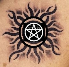 a tattoo with a pentagramil in the middle and sun on it's back