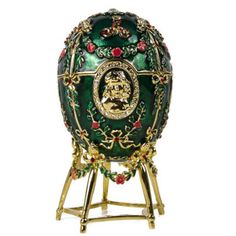 an ornately decorated green egg on a stand