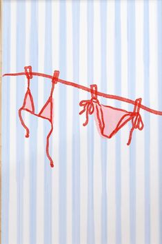 red clothes hanging on a line with striped background