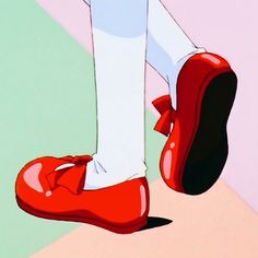 a close up of a person's feet wearing red shoes