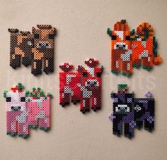 four pixelated animals are hanging on the wall