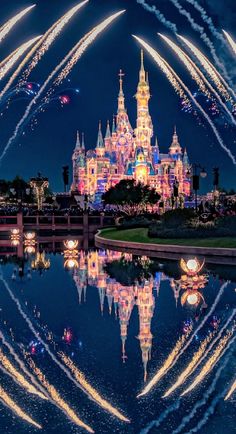 fireworks are lit up in the sky above a castle