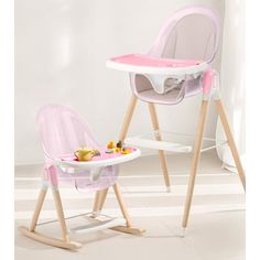 a child's high chair and tray with food on it in a white room