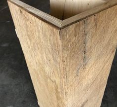 an unfinished wooden vase sitting on top of a table